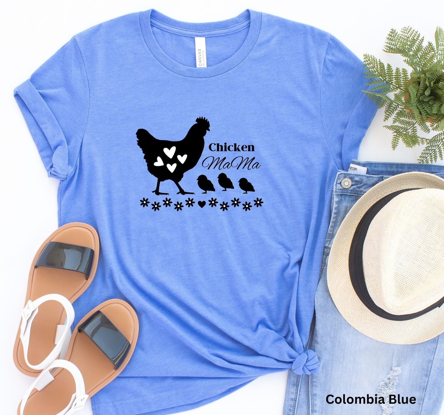 Light blue chicken Mama t-shirt featuring a hen with baby chicks and flowers, perfect for homesteaders, backyard chicken keepers, and farm life lovers.