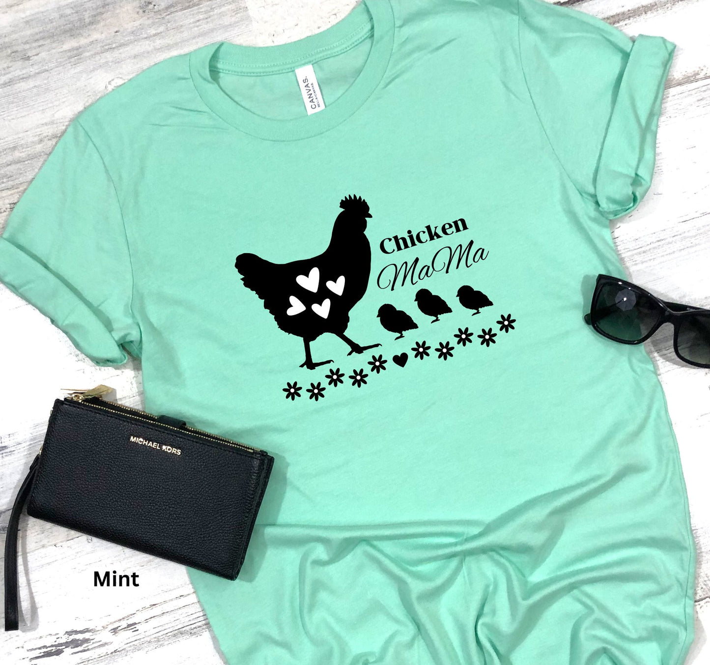 Mint Colored Chicken Mama t-shirt featuring a hen with baby chicks and flowers, perfect for homesteaders, backyard chicken keepers, and farm life lovers.