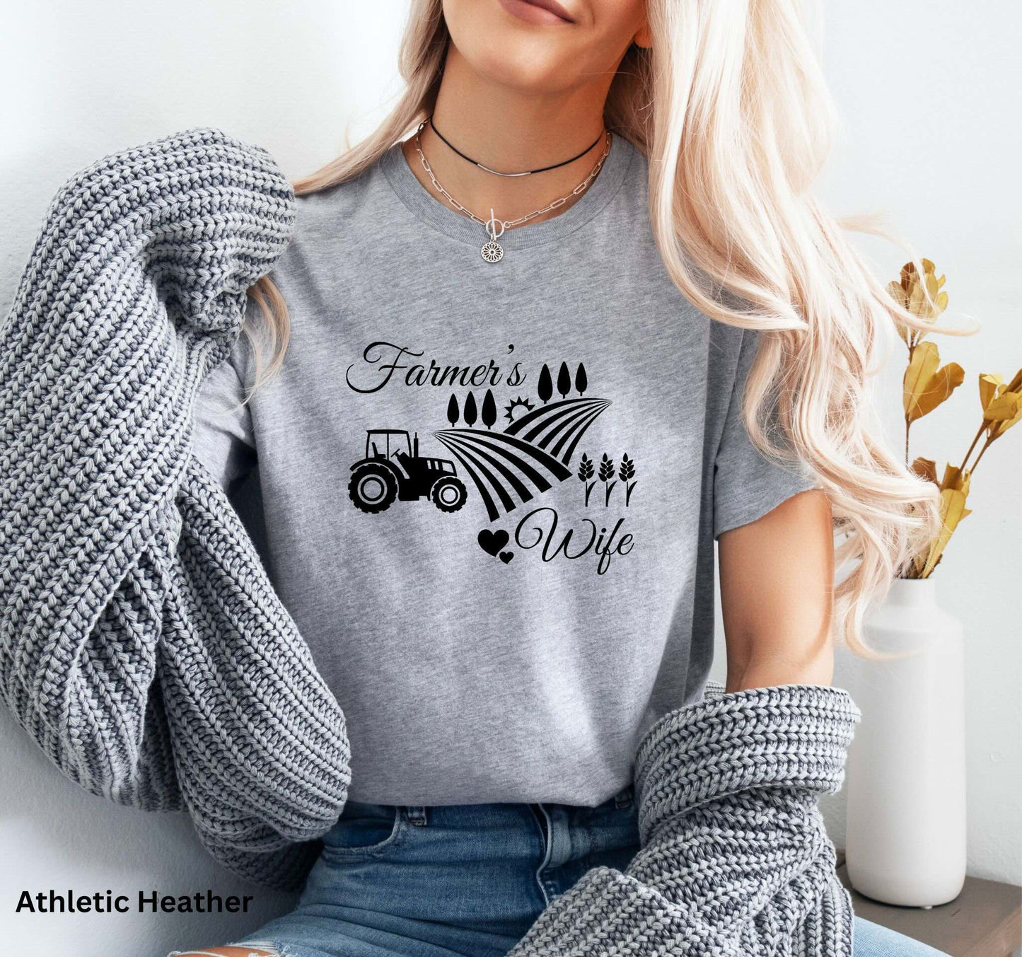 Farmer’s Wife light grey t-shirt with tractor, wheat field and heart design, celebrating country living and hardworking farm women.