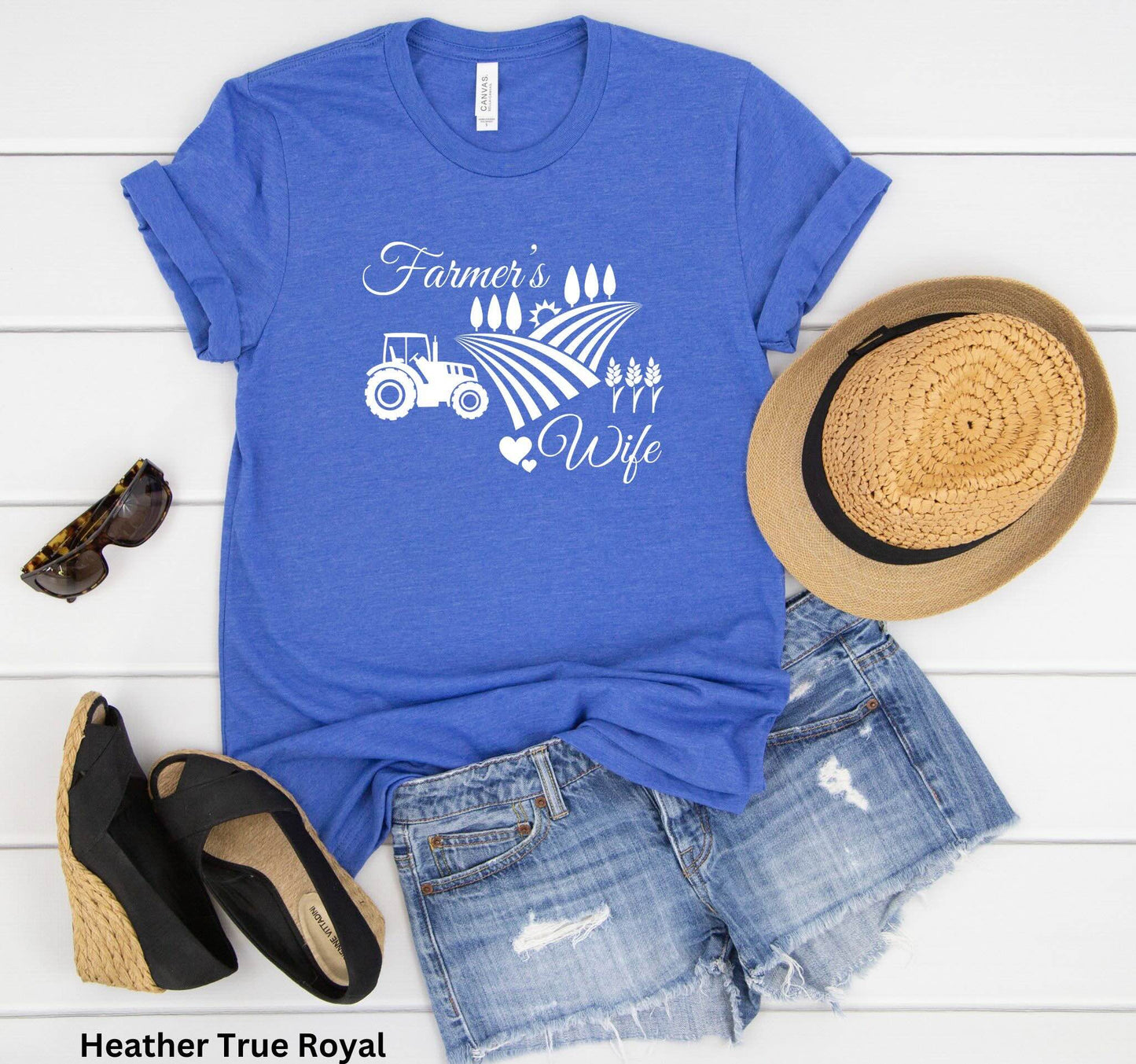 Farmer’s Wife blue t-shirt with tractor, wheat field and heart design, celebrating country living and hardworking farm women.