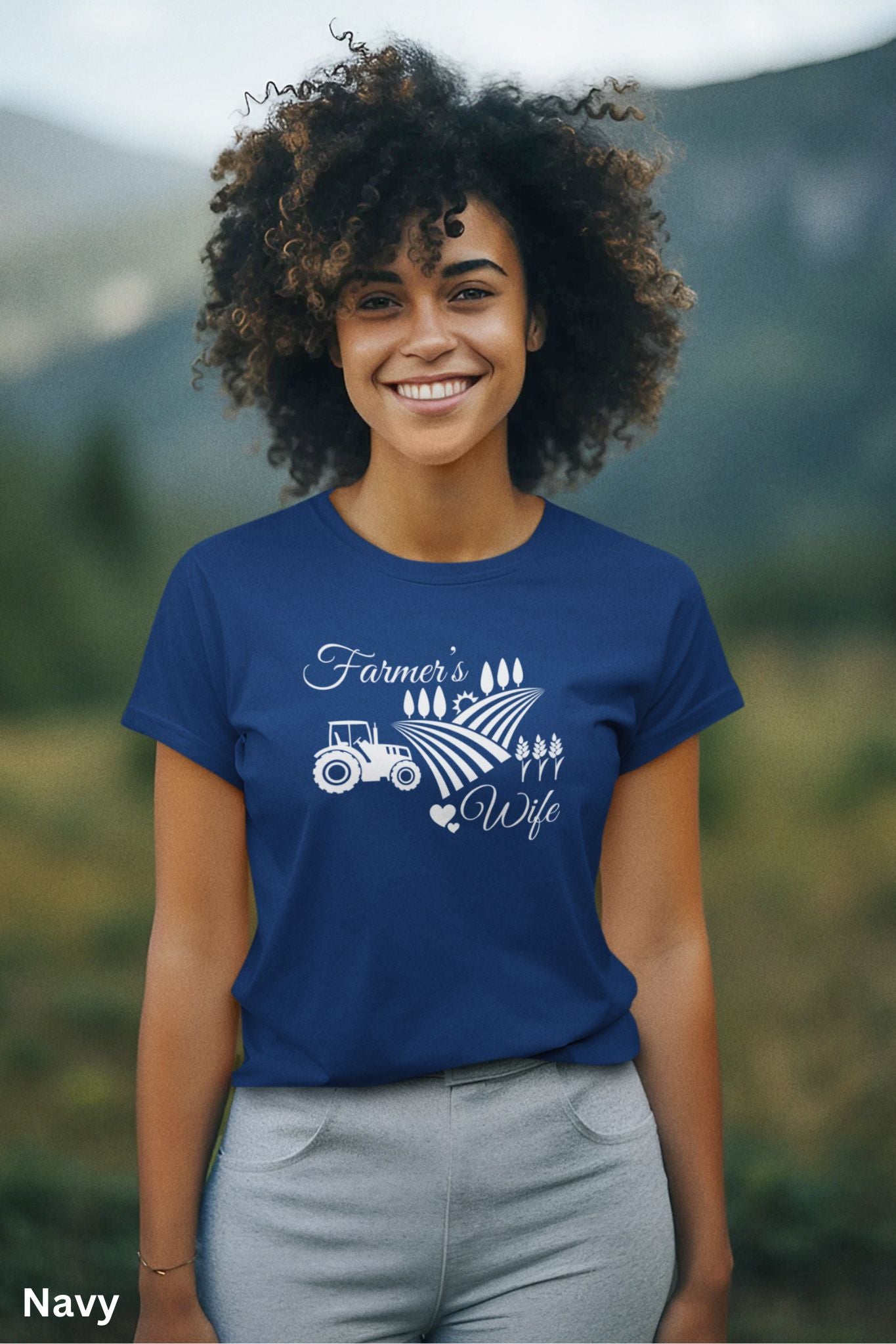 Farmer’s Wife navy blue t-shirt with tractor, wheat field and heart design, celebrating country living and hardworking farm women.
