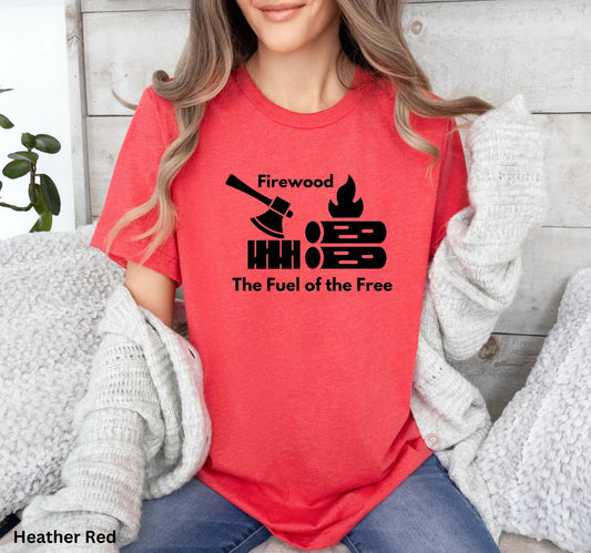 Red T-shirt with the phrase 'Firewood: The Fuel of the Free,' featuring a campfire, stacked firewood, and an ax—perfect for wood heat lovers and homesteaders.