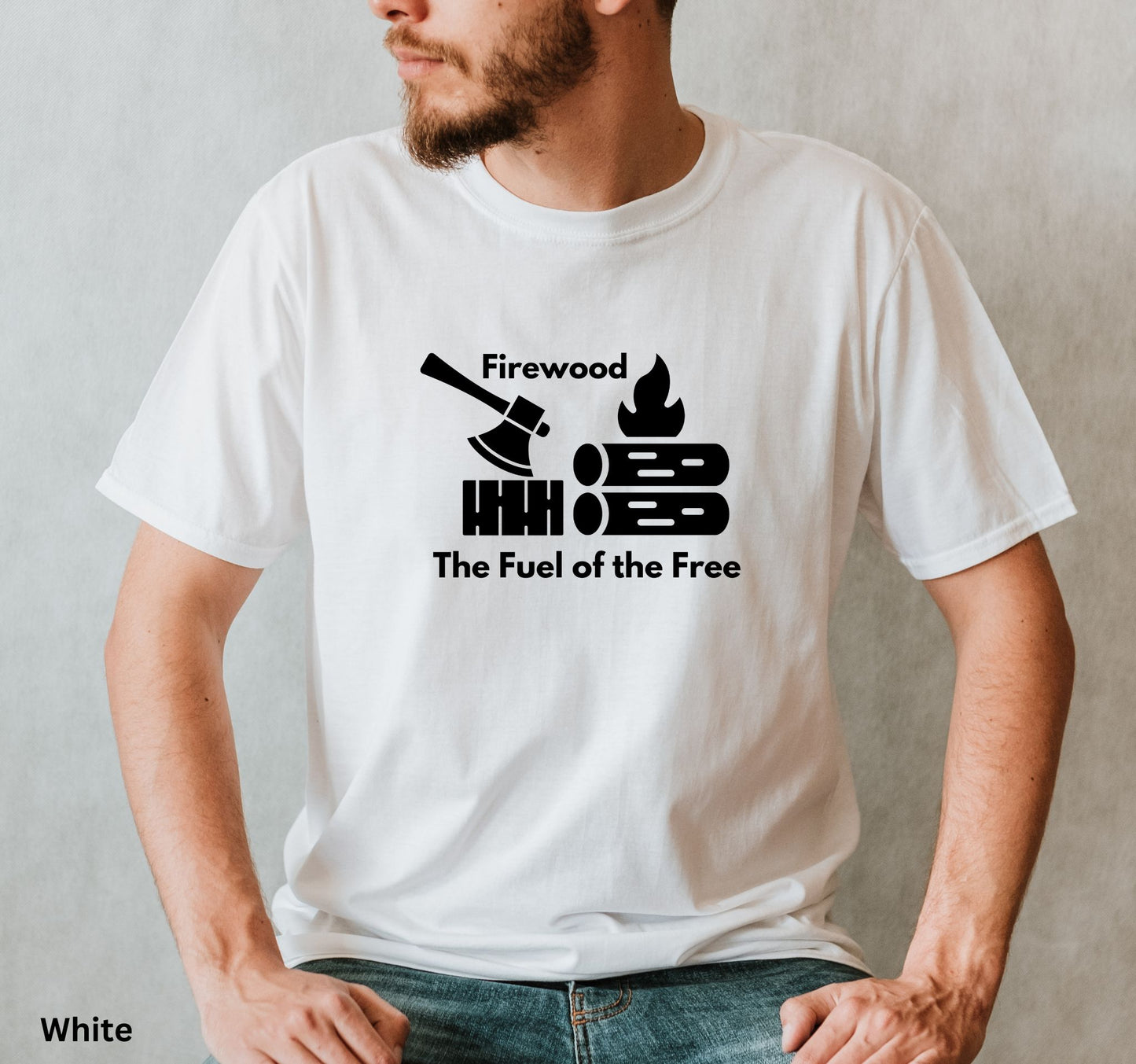 White T-shirt with the phrase 'Firewood: The Fuel of the Free,' featuring a campfire, stacked firewood, and an ax—perfect for wood heat lovers and homesteaders.