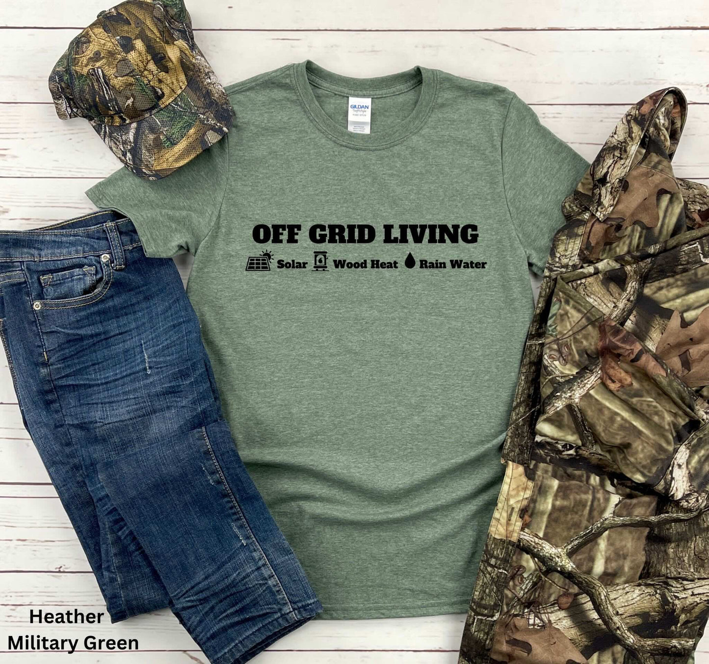 Off Grid Living t-shirt in Military Green featuring the words 'Off Grid Living' with icons representing solar power, wood heat, and rainwater—perfect for self-sufficiency and sustainable living.