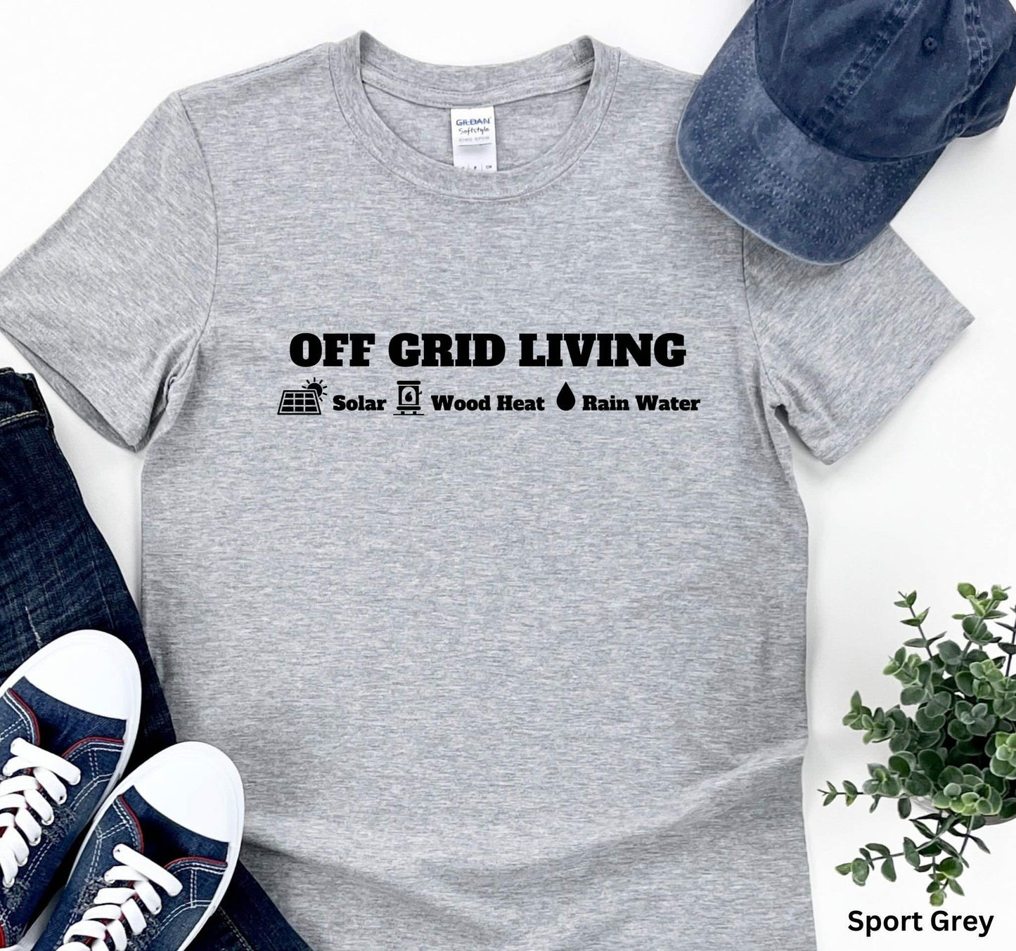 Light Grey Off Grid Living t-shirt featuring the words 'Off Grid Living' with icons representing solar power, wood heat, and rainwater—perfect for self-sufficiency and sustainable living.