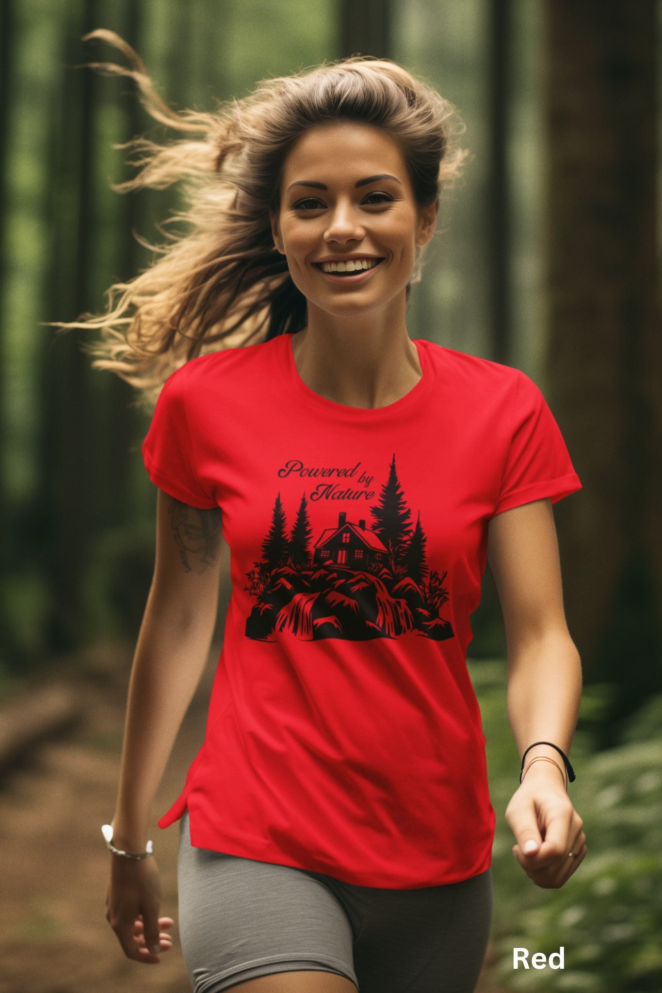 Red T-shirt with the phrase 'Powered by Nature,' featuring a detailed cabin in the woods, a cascading waterfall, and trees—perfect for outdoor and adventure lovers