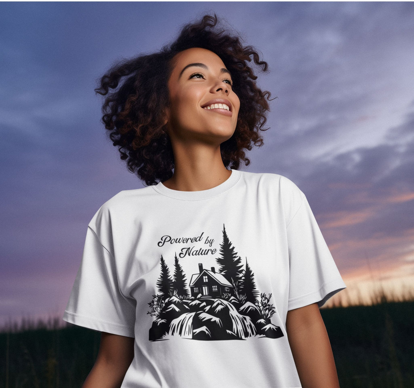 White T-shirt with the phrase 'Powered by Nature,' featuring a detailed cabin in the woods, a cascading waterfall, and trees—perfect for outdoor and adventure lovers