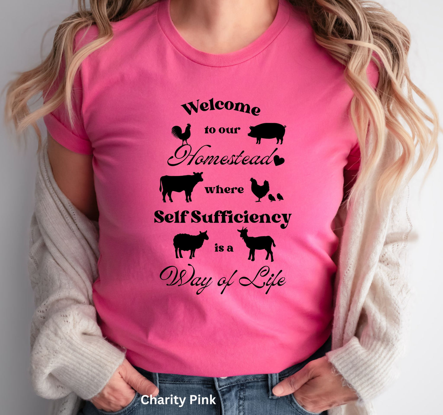 Pink Homestead t-shirt featuring the phrase 'Welcome to our Homestead where Self-Sufficiency is a Way of Life' with farm animals including a rooster, hen with chicks, pig, cow, sheep, and goat. Perfect for homesteaders and farm life lovers.