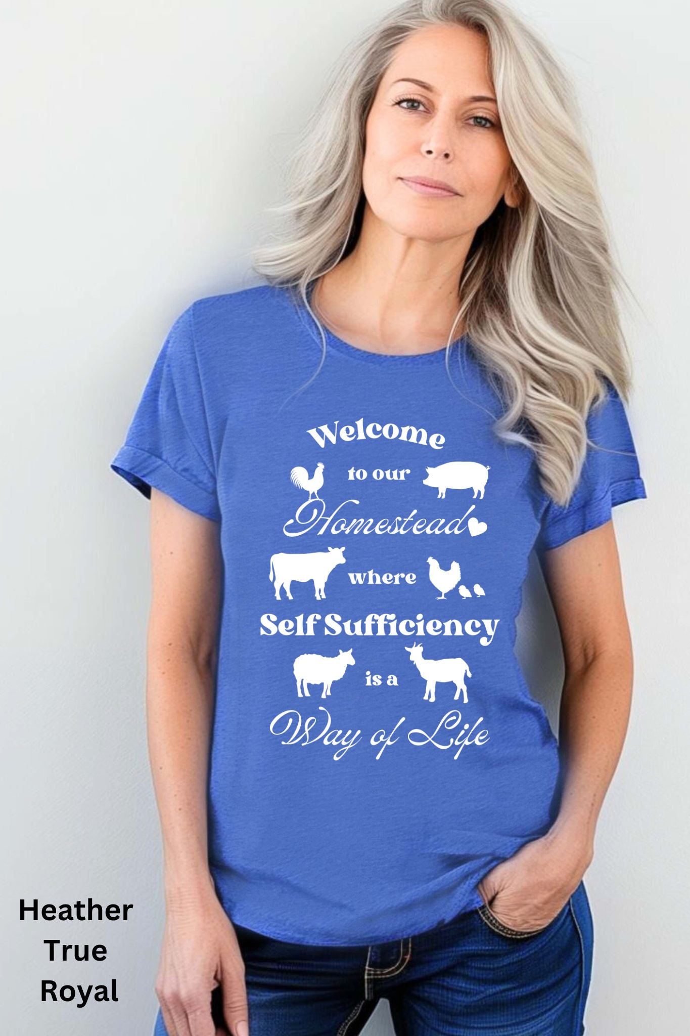 Blue Homestead t-shirt featuring the phrase 'Welcome to our Homestead where Self-Sufficiency is a Way of Life' with farm animals including a rooster, hen with chicks, pig, cow, sheep, and goat. Perfect for homesteaders and farm life lovers.