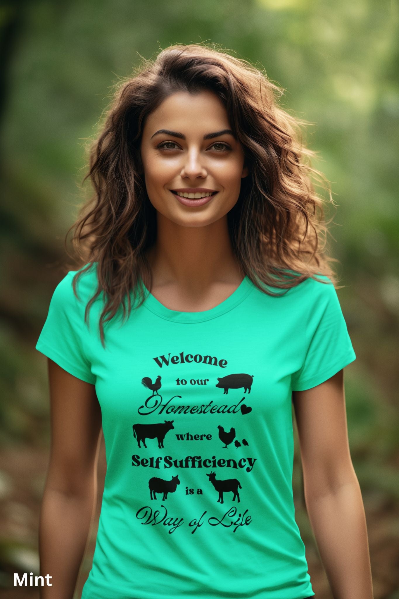Mint Homestead t-shirt featuring the phrase 'Welcome to our Homestead where Self-Sufficiency is a Way of Life' with farm animals including a rooster, hen with chicks, pig, cow, sheep, and goat. Perfect for homesteaders and farm life lovers.