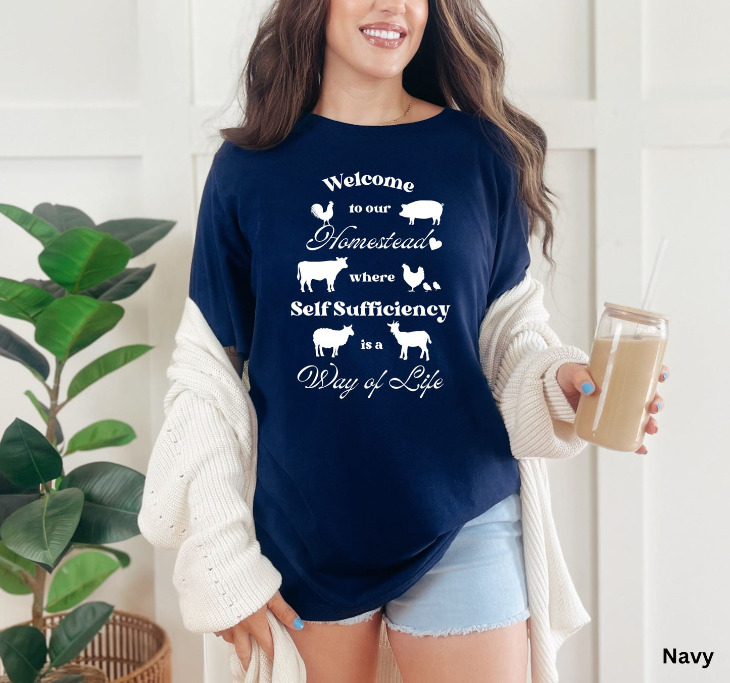 Navy Blue Homestead t-shirt featuring the phrase 'Welcome to our Homestead where Self-Sufficiency is a Way of Life' with farm animals including a rooster, hen with chicks, pig, cow, sheep, and goat. Perfect for homesteaders and farm life lovers.