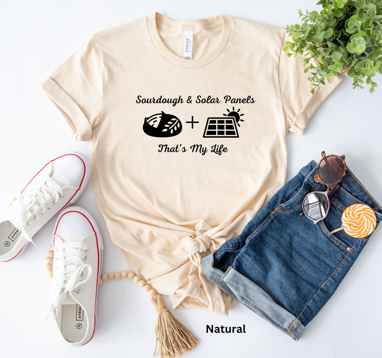 Natural colored T-shirt with the phrase 'Sourdough & Solar Panels, That’s My Life,' featuring a loaf of sourdough bread, a solar panel, and the sun—perfect for off-grid living.