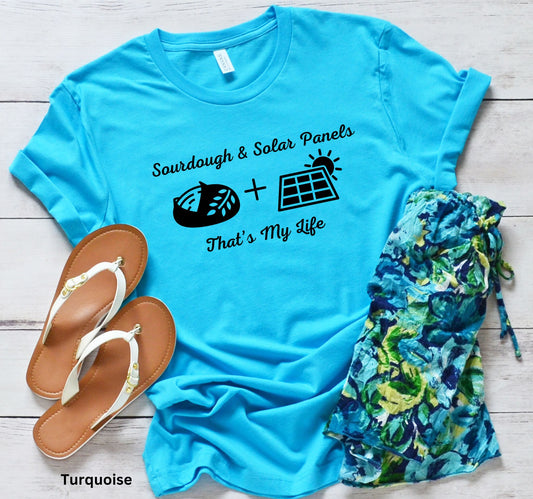 Turquoise T-shirt with the phrase 'Sourdough & Solar Panels, That’s My Life,' featuring a loaf of sourdough bread, a solar panel, and the sun—perfect for off-grid living.