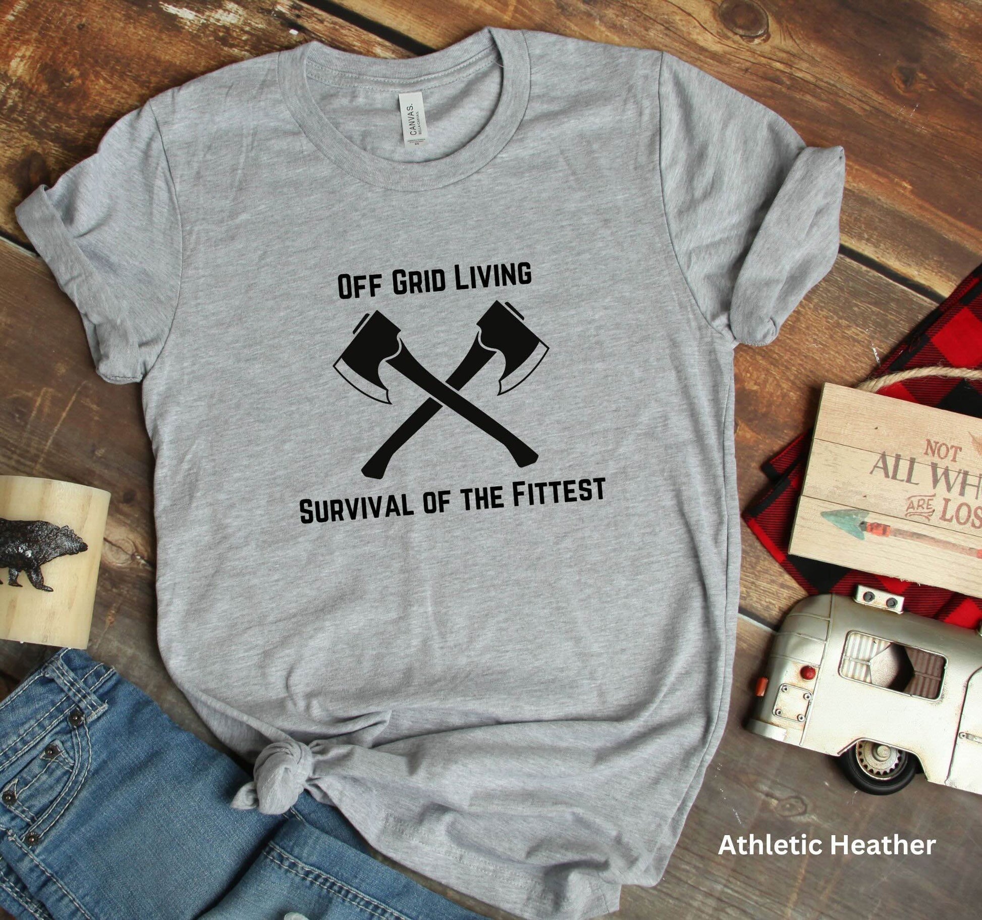 Off Grid Living t-shirt in light grey (Athletic Heather) with 'Survival of the Fittest' text and crossed axes design, survivalist and bushcraft graphic tee