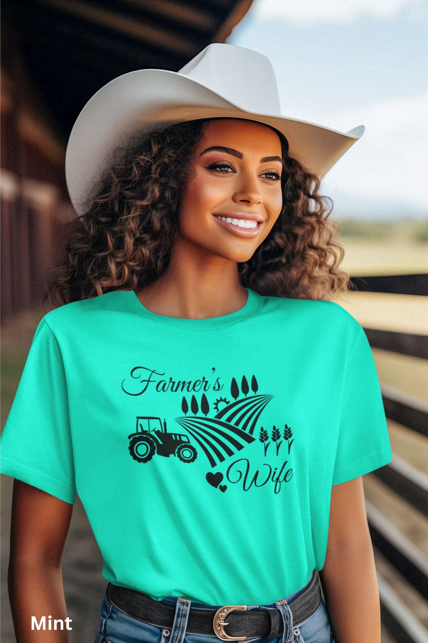 Farmer’s Wife mint colored t-shirt with tractor, wheat field and heart design, celebrating country living and hardworking farm women.