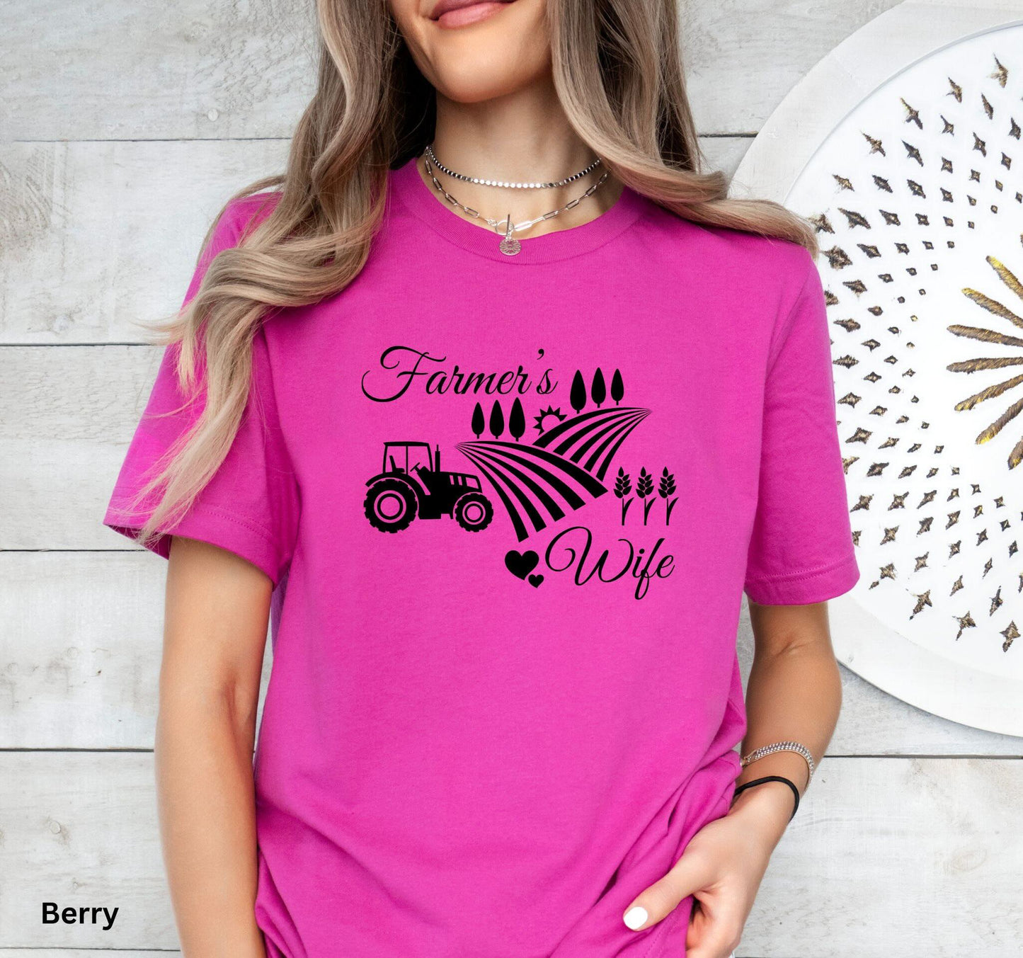 Farmer’s Wife deep pink t-shirt with tractor, wheat field and heart design, celebrating country living and hardworking farm women.