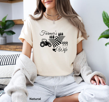 Farmer’s Wife t-shirt in natural color, with tractor, wheat field and heart design, celebrating country living and hardworking farm women.